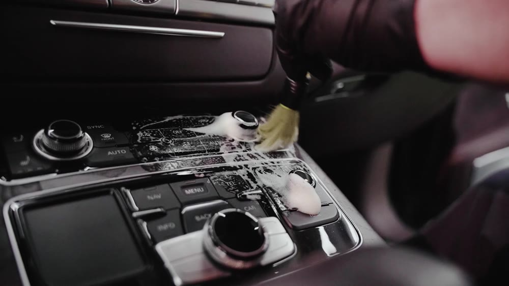 A brush cleaning the car centre console