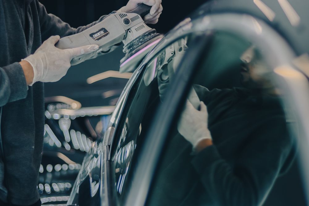 Close-up of a car being machine polished
