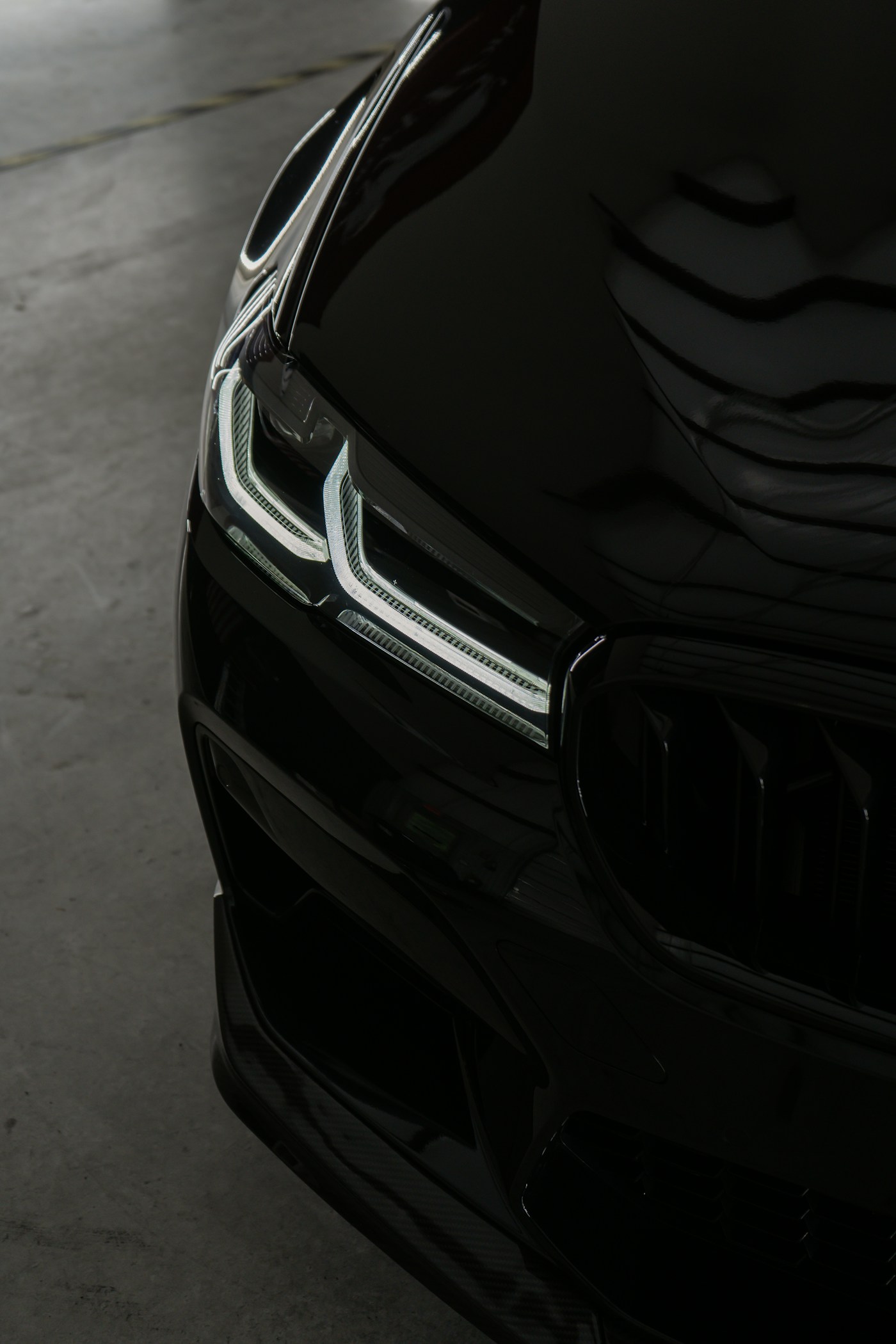 A glossy black BMW bonnet with clean reflections