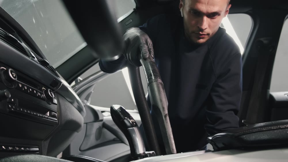 Car interior being vacuumed