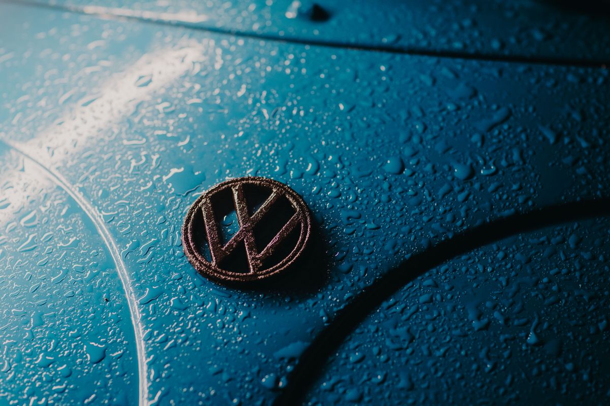 Water beading on a blue car bonnet